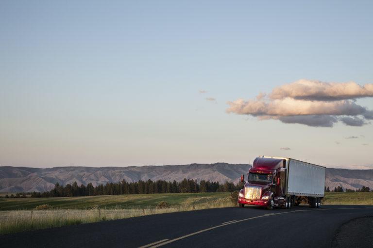 Truck on a highway through the grasslands area.